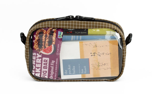 A Coyote (tan) with white grid pattern (Halcyon) 3D Clear Organizer Cube filled with sundries.
